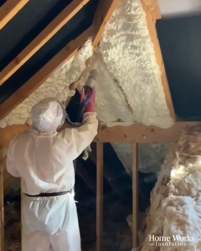 Spray foam insulation being applied to a wall cavity